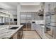 Bright kitchen with stainless appliances, granite countertops, tile backsplash, and open layout at 33 Hassayampa Trl, Henderson, NV 89052