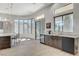 Open-concept kitchen features a marble countertop, breakfast bar, wine cooler, and stainless steel appliances at 33 Hassayampa Trl, Henderson, NV 89052