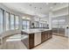Open-concept kitchen featuring a large island with seating, modern appliances, and tile floors at 33 Hassayampa Trl, Henderson, NV 89052