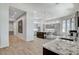 Spacious gourmet kitchen features marble countertops, an island, stainless appliances, and modern lighting at 33 Hassayampa Trl, Henderson, NV 89052