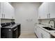 Well-equipped laundry room with modern washer and dryer and ample counter space at 33 Hassayampa Trl, Henderson, NV 89052