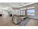 Spacious living room with modern furniture, wood floors, and large windows offering great views at 33 Hassayampa Trl, Henderson, NV 89052