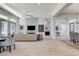 Large living room featuring tile floors, neutral decor, a fireplace, and smooth transition into the entry at 33 Hassayampa Trl, Henderson, NV 89052