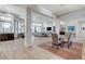 Open-concept living space with sleek tile flooring, a dining area, and stylish contemporary furnishings at 33 Hassayampa Trl, Henderson, NV 89052