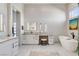 Bright main bathroom with soaking tub, double vanity, and modern lighting fixtures at 33 Hassayampa Trl, Henderson, NV 89052