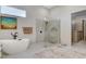 Modern main bathroom featuring a soaking tub, walk-in shower, and contemporary fixtures at 33 Hassayampa Trl, Henderson, NV 89052
