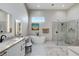 Luxurious main bathroom featuring modern fixtures, soaking tub, walk-in shower, and double vanity at 33 Hassayampa Trl, Henderson, NV 89052