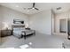 Bright main bedroom showcasing contemporary furnishings, neutral tones, and a ceiling fan at 33 Hassayampa Trl, Henderson, NV 89052