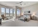 Spacious main bedroom featuring large windows, plush carpet, and stylish contemporary furnishings at 33 Hassayampa Trl, Henderson, NV 89052