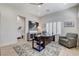 Bright home office with a desk, gray armchair, and a view into the ensuite bathroom, offering a functional workspace at 33 Hassayampa Trl, Henderson, NV 89052