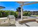 Outdoor built-in grill and outdoor spa is surrounded by lush landscaping at 33 Hassayampa Trl, Henderson, NV 89052