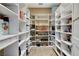Spacious walk-in pantry featuring ample white shelving for optimal storage and organization at 33 Hassayampa Trl, Henderson, NV 89052
