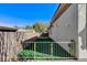 Small side yard with low-maintenance artificial turf and a gate, offering a secure and private space at 33 Hassayampa Trl, Henderson, NV 89052