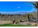 Serene backyard view of the city skyline and mountains, enhanced by a cozy seating area at 33 Hassayampa Trl, Henderson, NV 89052