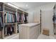 Organized walk-in closet with custom shelving, ample storage, and well-lit interior at 33 Hassayampa Trl, Henderson, NV 89052
