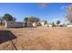Uncultivated backyard showing the home's exterior and potential for development at 352 Cox Ave, Overton, NV 89040