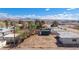 View of the backyard area, showing a partially fenced lot, shed, and mountain view in the distance at 352 Cox Ave, Overton, NV 89040