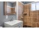 Updated bathroom featuring a walk-in shower with brown tile, new vanity and neutral paint at 352 Cox Ave, Overton, NV 89040
