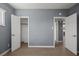 This bedroom has gray walls with modern wood flooring at 352 Cox Ave, Overton, NV 89040