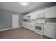Bright kitchen with white cabinets, modern appliances, and durable wood-look floors at 352 Cox Ave, Overton, NV 89040
