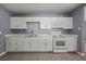 Bright kitchen with white cabinets, modern appliances, and durable wood-look floors at 352 Cox Ave, Overton, NV 89040