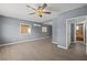 Modern living room with gray walls, wood-look floors, and a ceiling fan at 352 Cox Ave, Overton, NV 89040