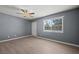 Bright living room with wood-look floors, gray walls, and a large window overlooking the yard at 352 Cox Ave, Overton, NV 89040