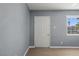 Neutral interior with a window bringing in light, a door, and durable wood-look floors at 352 Cox Ave, Overton, NV 89040