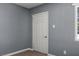 Neutral interior with a window bringing in light, a door, and durable wood-look floors at 352 Cox Ave, Overton, NV 89040