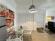 Dining area featuring a glass-top table, modern lighting, art and convenient access to the kitchen and entry at 3550 Bay Sands Dr # 1101, Laughlin, NV 89029