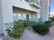 Exterior view of a building with a private patio featuring outdoor seating and lush landscaping at 3550 Bay Sands Dr # 1101, Laughlin, NV 89029