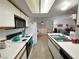 Bright kitchen featuring white appliances and cabinets, with a skylight and tile floor at 3550 Bay Sands Dr # 1101, Laughlin, NV 89029