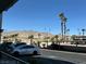 Well-maintained parking lot with ample spaces, palm trees, and mountain views in the background at 3550 Bay Sands Dr # 1101, Laughlin, NV 89029