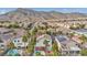 An aerial view of a neighborhood with lush landscaping and mountain views at 3728 Russell Peterson Ct, Las Vegas, NV 89129