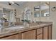 Bathroom featuring dual sinks, granite counters, and a bright vanity area at 3728 Russell Peterson Ct, Las Vegas, NV 89129