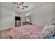 Bright bedroom featuring wood floors, ceiling fan and closet, providing a comfortable and stylish space at 3728 Russell Peterson Ct, Las Vegas, NV 89129