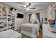 Comfortable bedroom with bed, shelving unit, and window with dark curtains at 3728 Russell Peterson Ct, Las Vegas, NV 89129