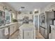 Well-equipped kitchen with stainless steel appliances, island, and custom white cabinets at 3728 Russell Peterson Ct, Las Vegas, NV 89129