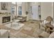Inviting living room featuring a fireplace, neutral walls, stone floors, and ample natural light at 3728 Russell Peterson Ct, Las Vegas, NV 89129