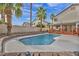 A serene pool with palm trees and a spacious deck for relaxation and entertainment at 3728 Russell Peterson Ct, Las Vegas, NV 89129