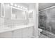 Bright bathroom featuring dual vanity and modern walk-in shower with glass doors at 3944 Visby Ln, Las Vegas, NV 89119