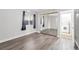 Bright bedroom with wood-look floors, a large mirrored closet, and a window for natural light at 3944 Visby Ln, Las Vegas, NV 89119