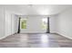 Spacious bedroom with wood-look floors, two windows, and a closet with sliding doors at 3944 Visby Ln, Las Vegas, NV 89119