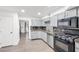 Modern kitchen with stainless steel appliances, stylish backsplash, and wood flooring at 3944 Visby Ln, Las Vegas, NV 89119