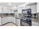 Well-designed kitchen with gray cabinetry, black appliances, and ample counter space at 3944 Visby Ln, Las Vegas, NV 89119