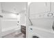 Bathroom featuring stacked washer and dryer next to vanity with sleek countertop and cabinet at 3944 Visby Ln, Las Vegas, NV 89119