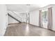 Open living room with hardwood floors, modern staircase, and lots of natural light at 3944 Visby Ln, Las Vegas, NV 89119