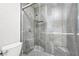 Close-up of walk-in shower with gray tile and mosaic shower floor at 3944 Visby Ln, Las Vegas, NV 89119