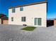Low maintenance backyard with sliding glass door and gravel landscaping at 3981 E Teller Dr, Pahrump, NV 89061
