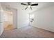 Bedroom with ceiling fan and plush carpet flooring and view into open hallway at 3981 E Teller Dr, Pahrump, NV 89061